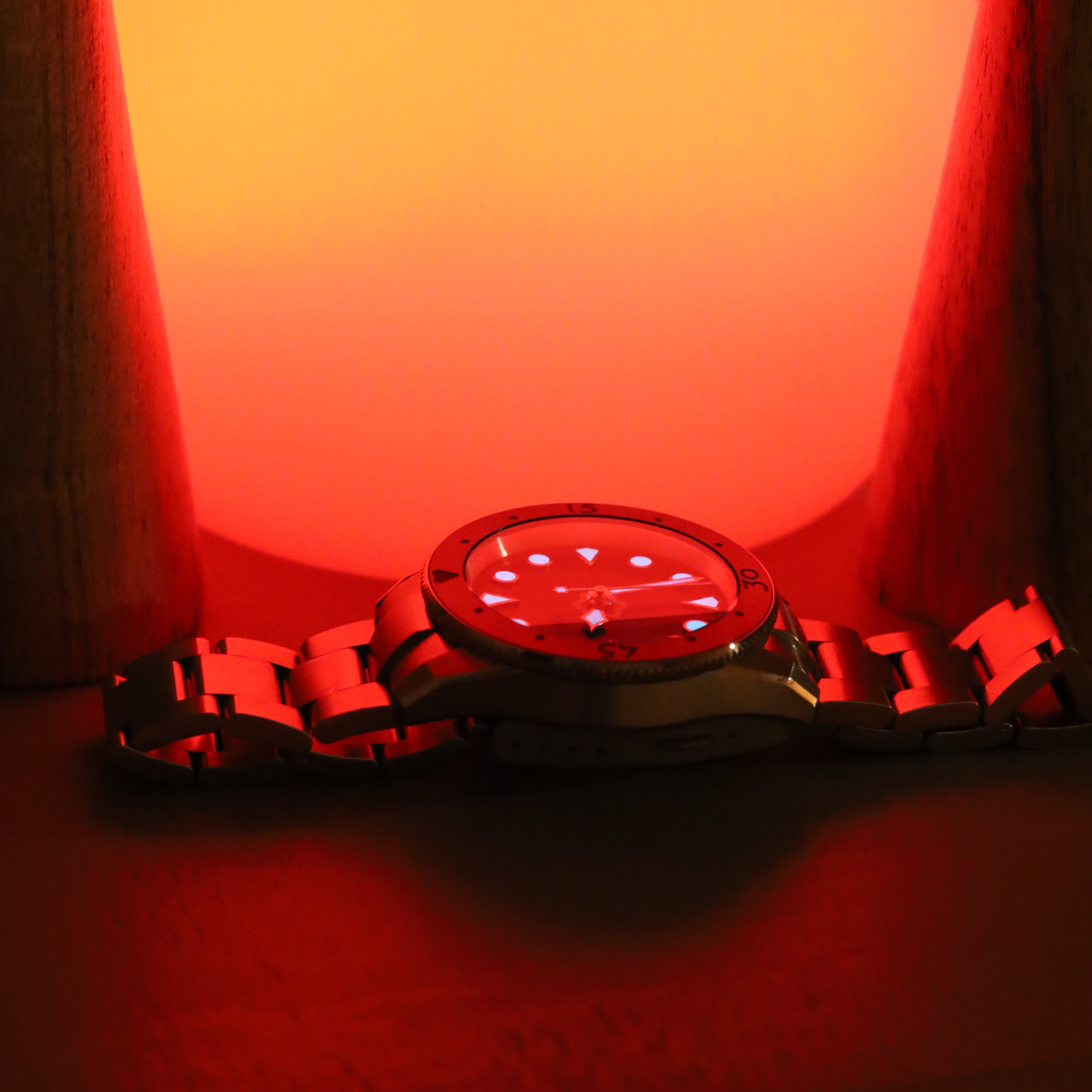Futuristic wristband with digital display against a red and orange gradient background