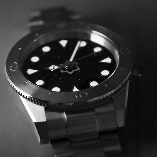 Black wristwatch with a unique design on a dark background